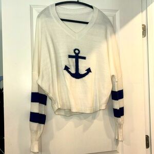 Knitted sweatshirt with blue anchor in the middle